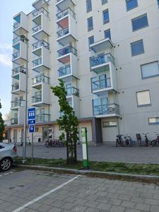 a large apartment building with bikes parked in front of it at Kampuksen Tähti in Pori