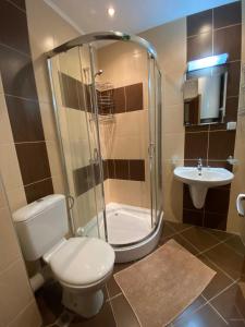 a bathroom with a shower and a toilet and a sink at Marina Park OLIWIA in Sveti Vlas +10 photos