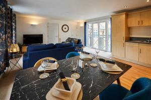 a living room with a table and a blue couch at Modern Comfort 2BR Flat with Free Parking in Oadby in Oadby