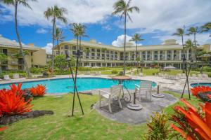 a resort with a pool and a table and chairs at Lagoon View Resort Retreat in Lihue