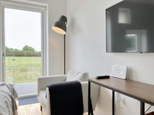 a room with a desk and a chair and a lamp at Convenient Apartment for 2 in Aarhus