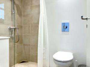 a bathroom with a shower with a toilet and a shower curtain at Convenient Apartment for 2 in Aarhus +7 photos