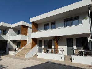 an exterior view of a building with balconies at Heleon Luxury Apartments in Parga