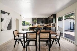 a kitchen and dining room with a table and chairs at 2-Story Sanctuary - Spacious Hot Tub - Billiards in Los Angeles