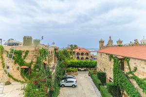 an aerial view of a castle with cars parked in a courtyard at Paira's Chic Apartments & Studio in Batroun in Ed Daourâ