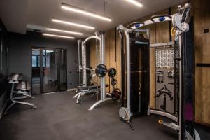 a gym with several treadmills and machines at NEW Premium Club SPA in Bukovel