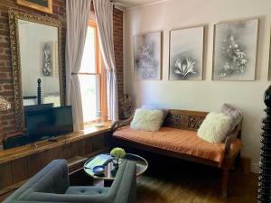 a living room with a couch and a tv at Main Street Glorious Penthouse in Telluride
