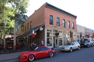 a red car parked on a street in front of a building at Main Street Glorious Penthouse in Telluride