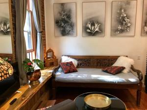 a living room with a couch and some pictures on the wall at Main Street Glorious Penthouse in Telluride