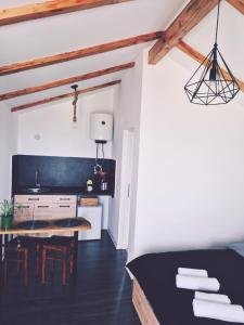 a kitchen and dining room with a table and chairs at La Ograda - Cheile Turzii, near Turda in Sănduleşti
