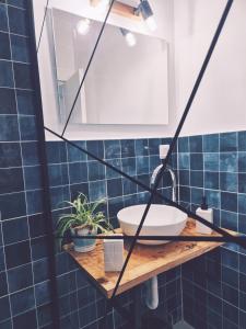 a bathroom with a sink and blue tiles at La Ograda - Cheile Turzii, near Turda in Sănduleşti