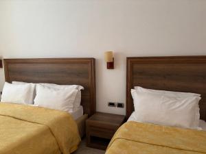 Postel nebo postele na pokoji v ubytování Grand Resort by Greccia Dhermi Prime