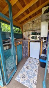 an outside view of a kitchen in an rv at La Yourte climatisée du Jardin Caché in Marmande