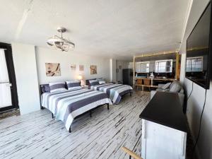 a bedroom with two beds and a living room at Fabulous Oceanfront Studio w/kitchen, tiki bar in Daytona Beach +41 photos