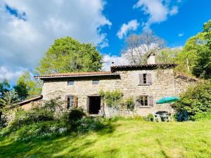 an old stone house on a grassy hill at Le Cheix in Ambert