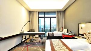 a hotel room with a desk and a bed at Menara M101 Kuala Lumpur By Oak Tree in Kuala Lumpur