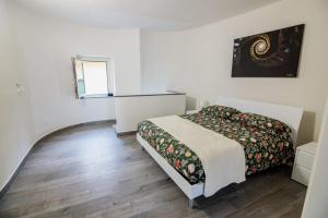 a small bedroom with a bed and a window at La Casa del Don in Capua