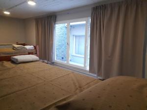 a bedroom with a large window and a bed at Guanaco Hostel in Puerto Madryn