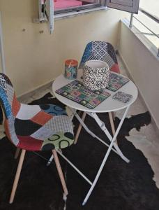 a table and two chairs in a room at Ilia's Coastal Apartement in Vlorë