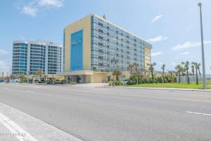 a large building on the side of a road at Sunrise Oceanfront 2 Full Studio w/kitchen & pool in Daytona Beach