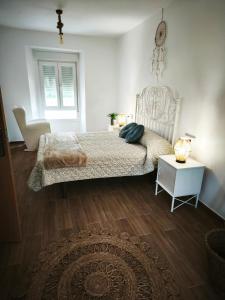 a bedroom with a bed and a chair and a table at Villa Adelina in Heres +4 photos