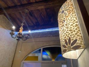 a chandelier hanging over a door with a window at Casetta in Piazza in Nepi