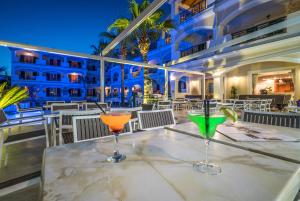 two cocktails sitting on a table on the balcony of a hotel at Zante Atlantis Hotel in Laganas