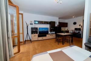 a room with a bed and a table and a television at RobertONE guest house 14 in Bari