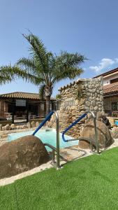 a swimming pool with a slide in a yard at Residencial La Teja in Zahora