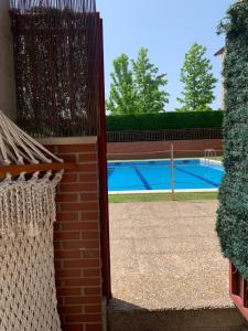 a fence in front of a swimming pool at Melgar's Place, Bajo con terraza in Santo Domingo de la Calzada