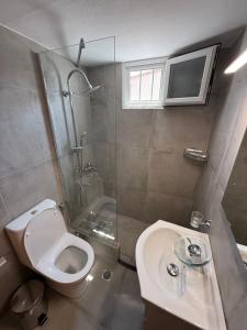 a bathroom with a toilet and a shower and a sink at Prime Diakopto in Diakopto +22 photos