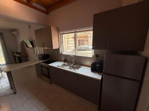 a kitchen with a sink and a refrigerator at Prime Diakopto in Diakopto