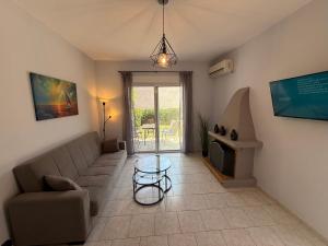 a living room with a couch and a table at Prime Diakopto in Diakopto