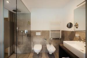 a bathroom with a toilet and a sink and a shower at Antholzer Wildsee Haus in San Giuseppe in Anterselva