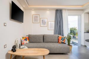 a living room with a couch and a table at Diamante Del Mar Thalia and Erato in Kos