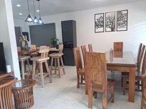a dining room with wooden tables and chairs at AA villa in Calodyne