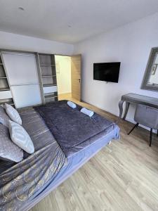 a bedroom with a bed and a tv and a desk at Chic & glamour Dubai Style in Flers-en-Escribeus