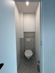 a bathroom with a toilet in a small room at Pauline in Neuilly-sur-Seine