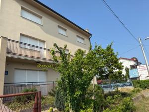 a building with a fence in front of it at Rooms Stella in Sesvete