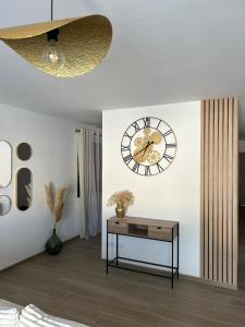 a living room with a clock and a table at Villa avec piscine en Provence in Les Mées
