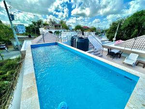a blue swimming pool on top of a house at Villa Colonial Room 5 in Río San Juan