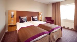 Ένα ή περισσότερα κρεβάτια σε δωμάτιο στο Home Hotel Kompaniet