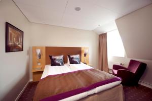 Ένα ή περισσότερα κρεβάτια σε δωμάτιο στο Home Hotel Kompaniet