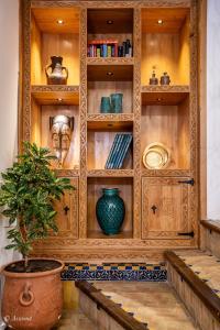 a wooden hutch with a potted plant in a room at Dar Bleumain in Chefchaouen