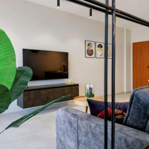 a living room with a couch and a bed at Ika Delux in Burgas