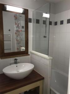 a bathroom with a white sink and a shower at Apartment for 6 - Residence Pierre & Vacances in Moliets-et-Maa +5 photos
