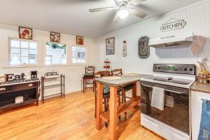 a kitchen with a stove top oven next to a table at Lake and Mtn Views Vermont Couples Retreat! in Barton