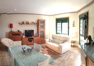 a living room with a couch and a table at Casa A RODA in Salcidos