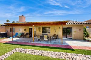 a house with a patio with a table and chairs at Desert Hot Springs Cozy Retreat in Desert Hot Springs