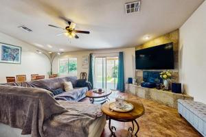 a living room with a couch and a tv at Desert Hot Springs Cozy Retreat in Desert Hot Springs